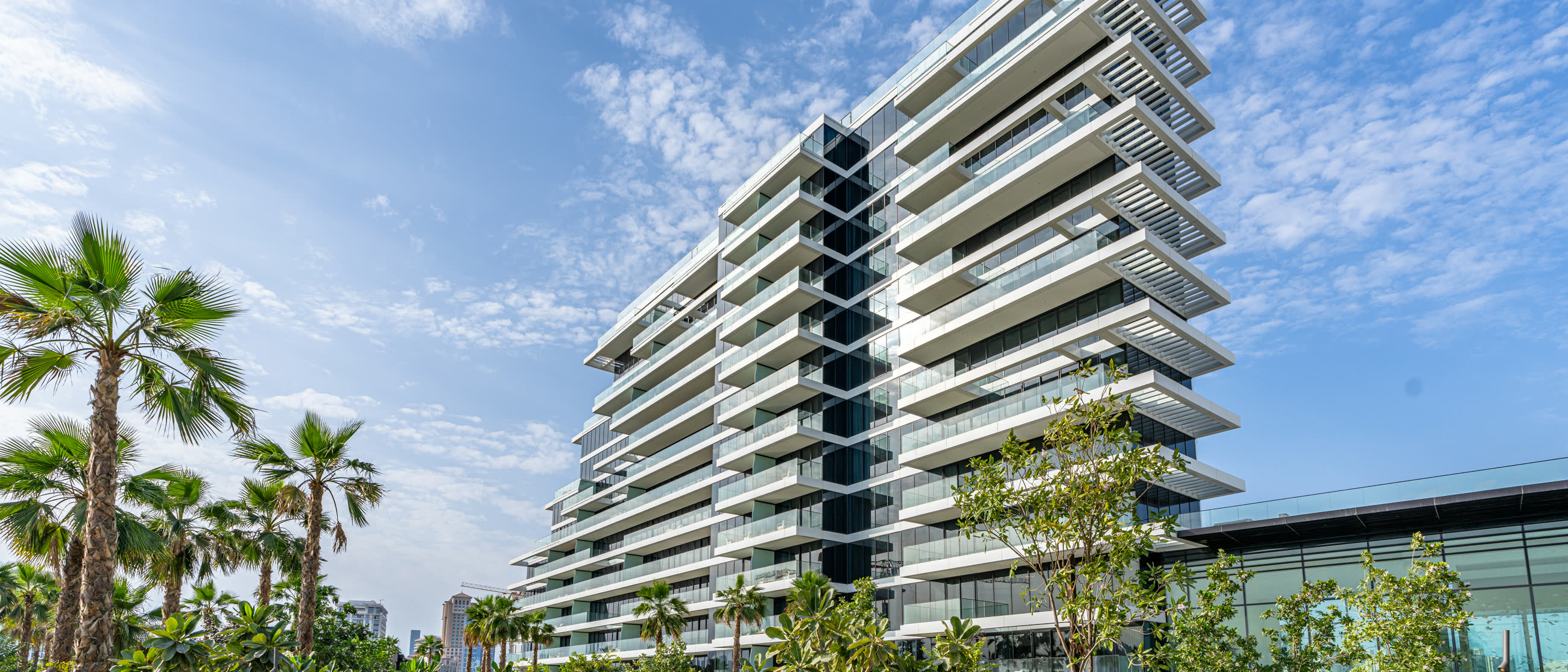 Kempinski Residences The Creek, the completed building seen from its gardens.
