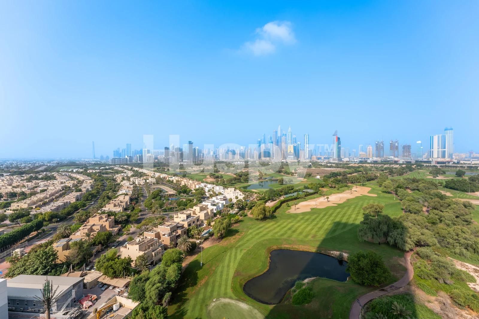 Green fairways and Dubai skyline seen from the apartment