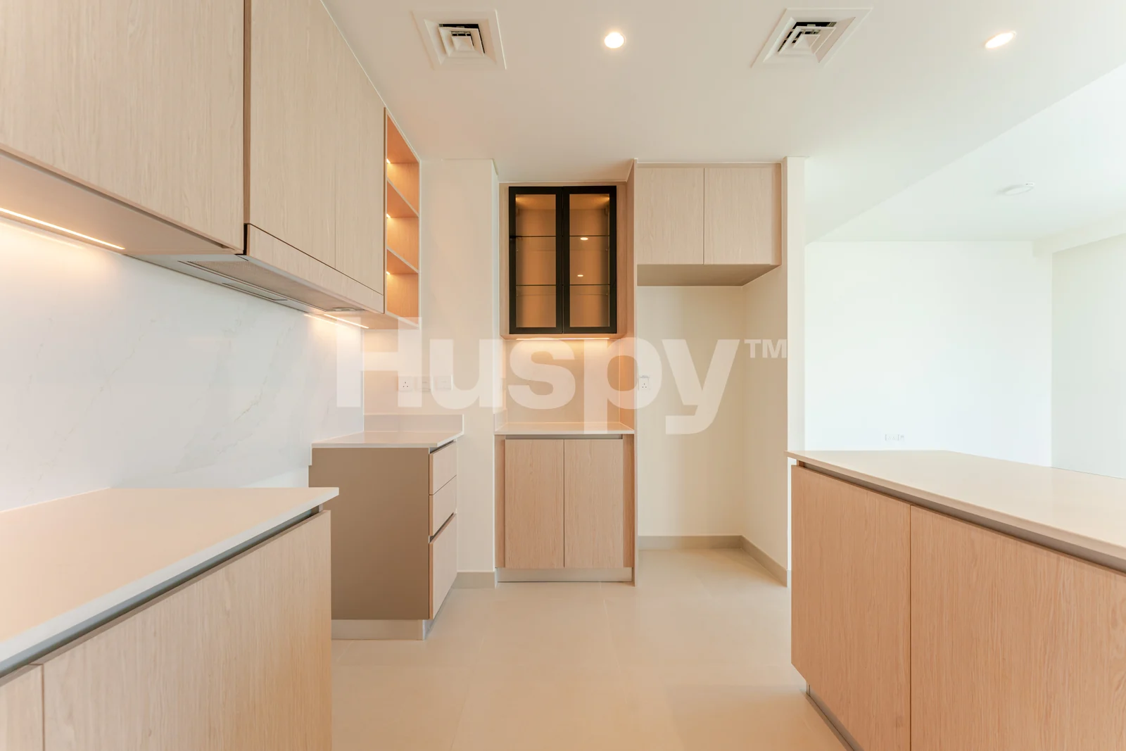 Kitchen with pale worktops and timber cupboards