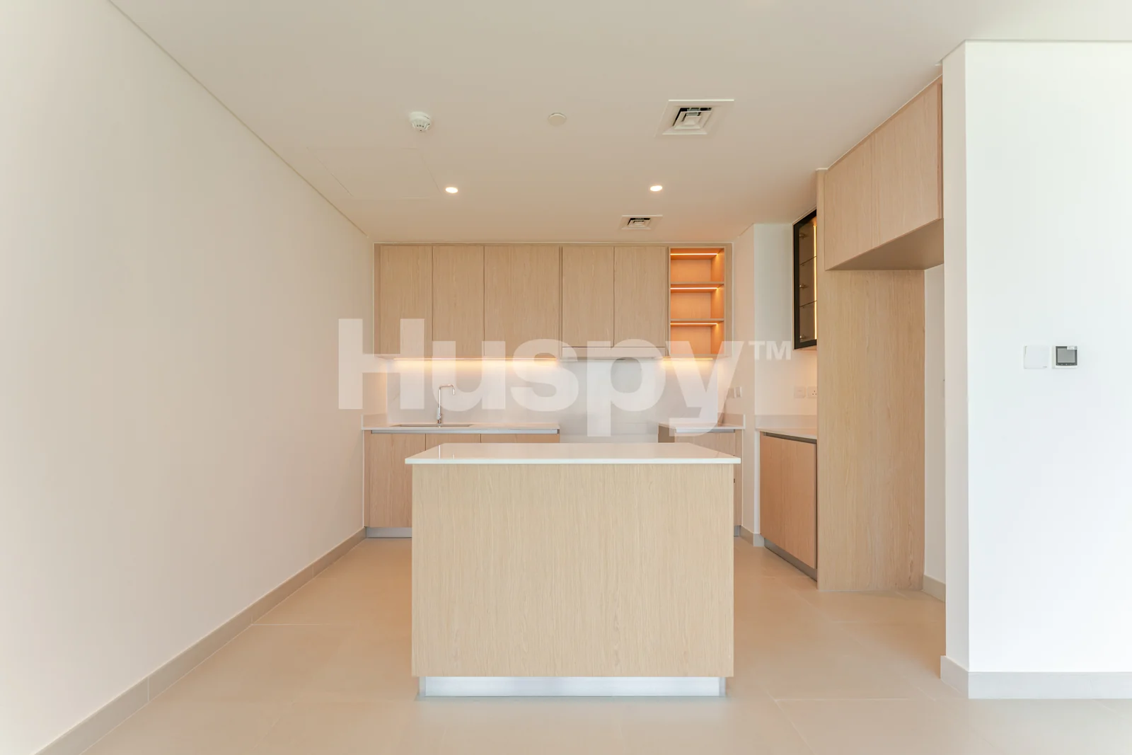 Kitchen island and timber cabinetry beside the living space