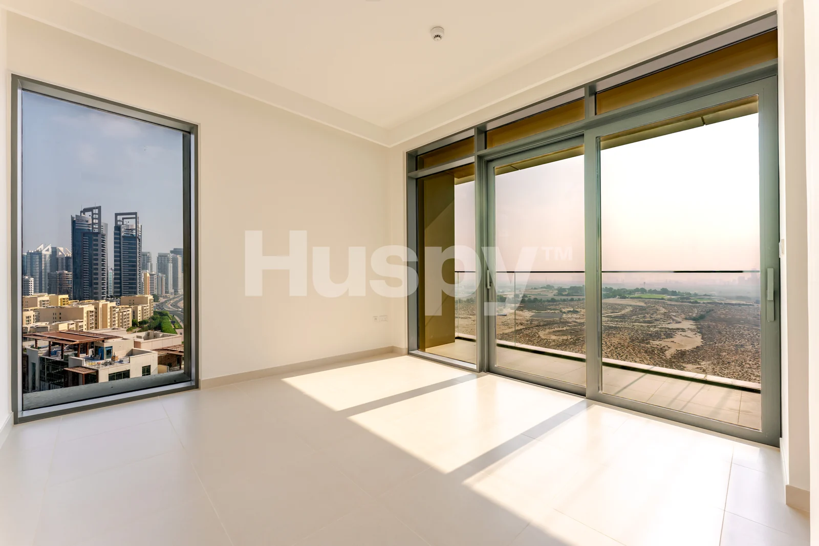 Primary bedroom with corner windows and balcony access