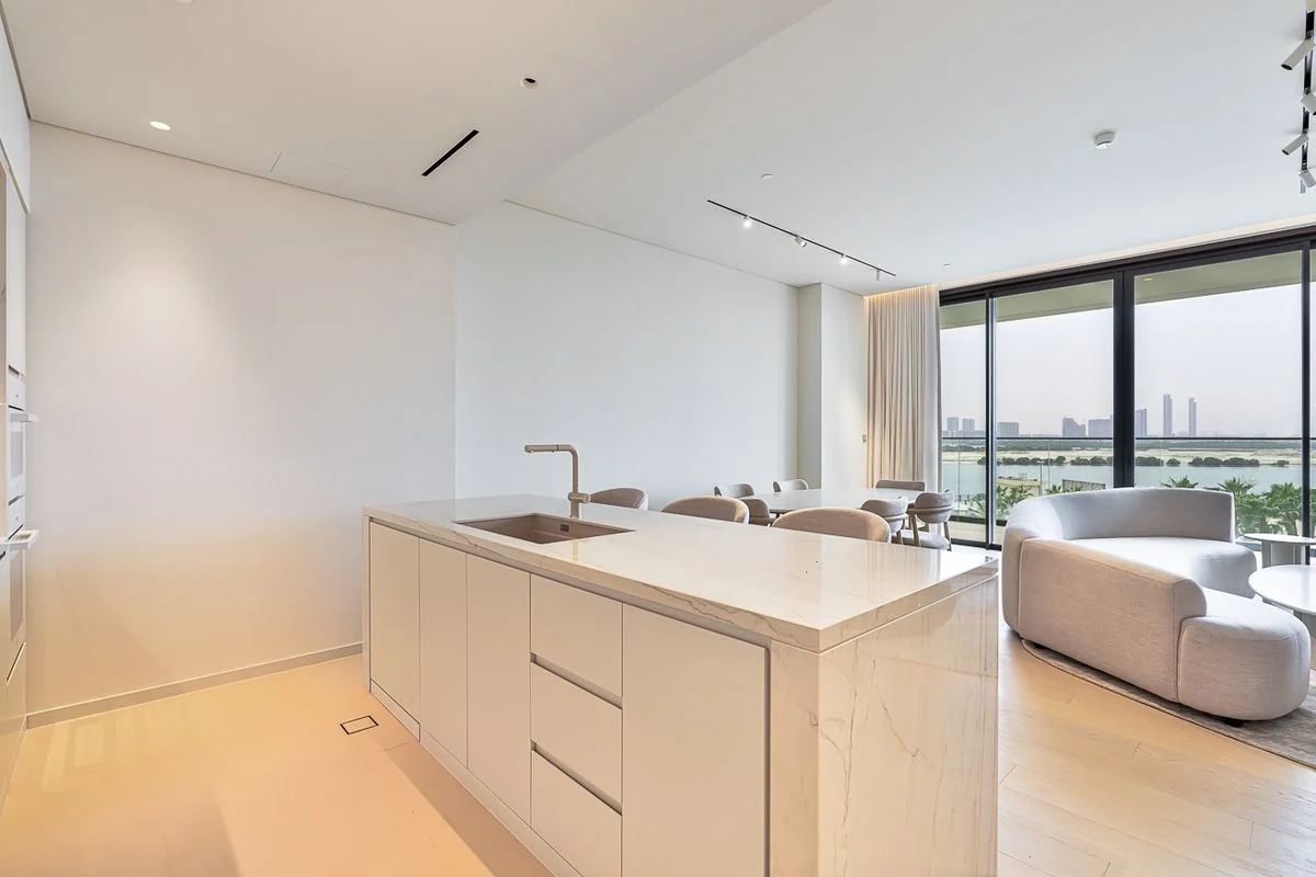 Furnished living, dining and kitchen spaces