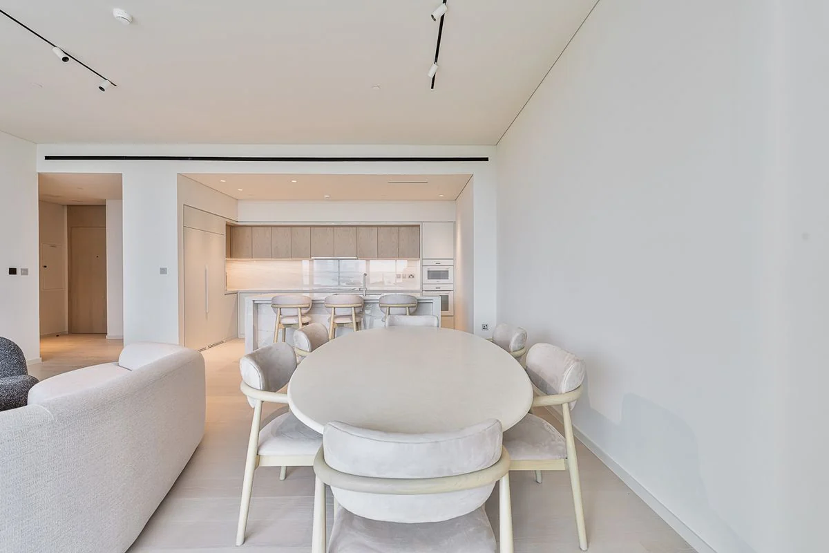 Furnished living, dining and kitchen spaces
