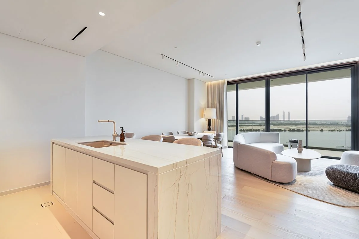 Furnished living, dining and kitchen spaces