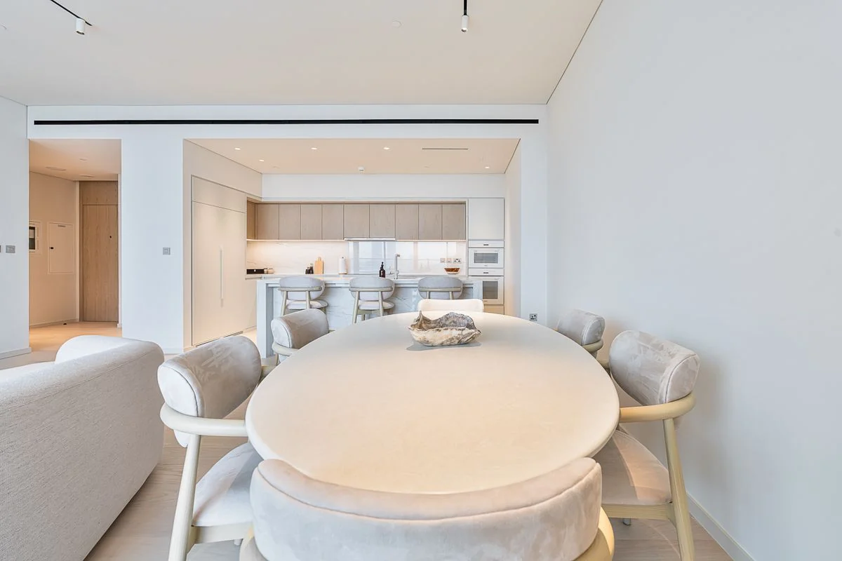 Furnished living, dining and kitchen spaces