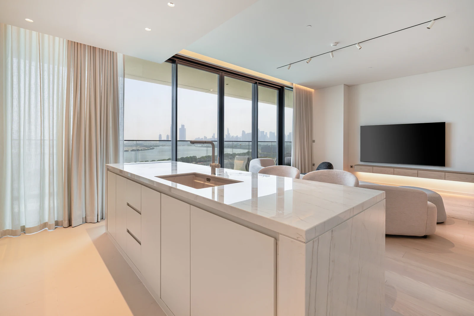 Kitchen island overlooking the living room and Dubai Creek