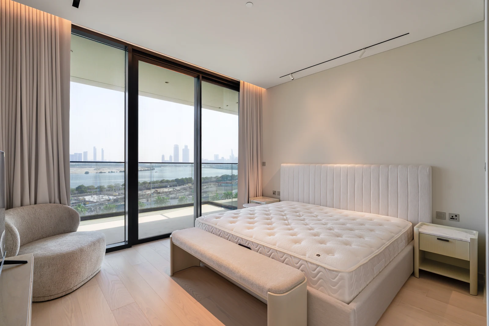 Primary bedroom with balcony doors and Creek outlook