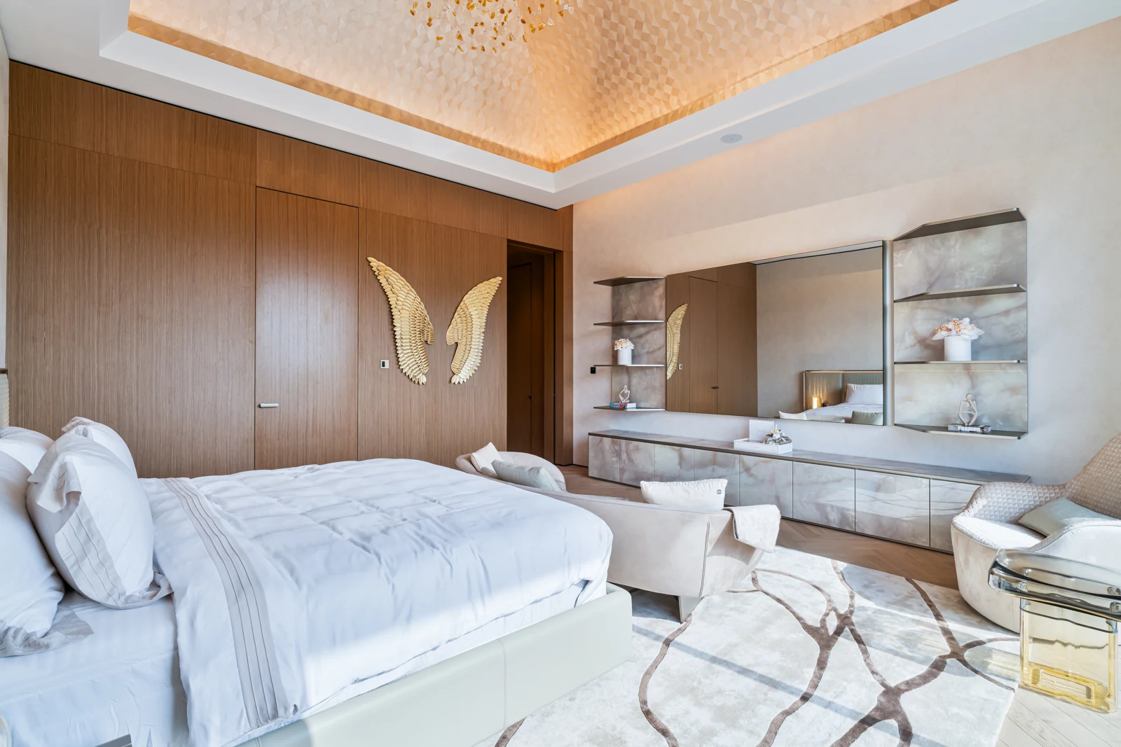 Primary suite with upholstered wall and fitted cabinetry